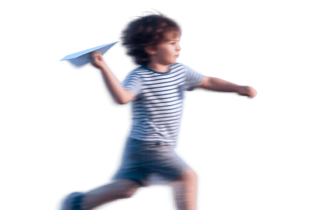 A child running with a paper plane