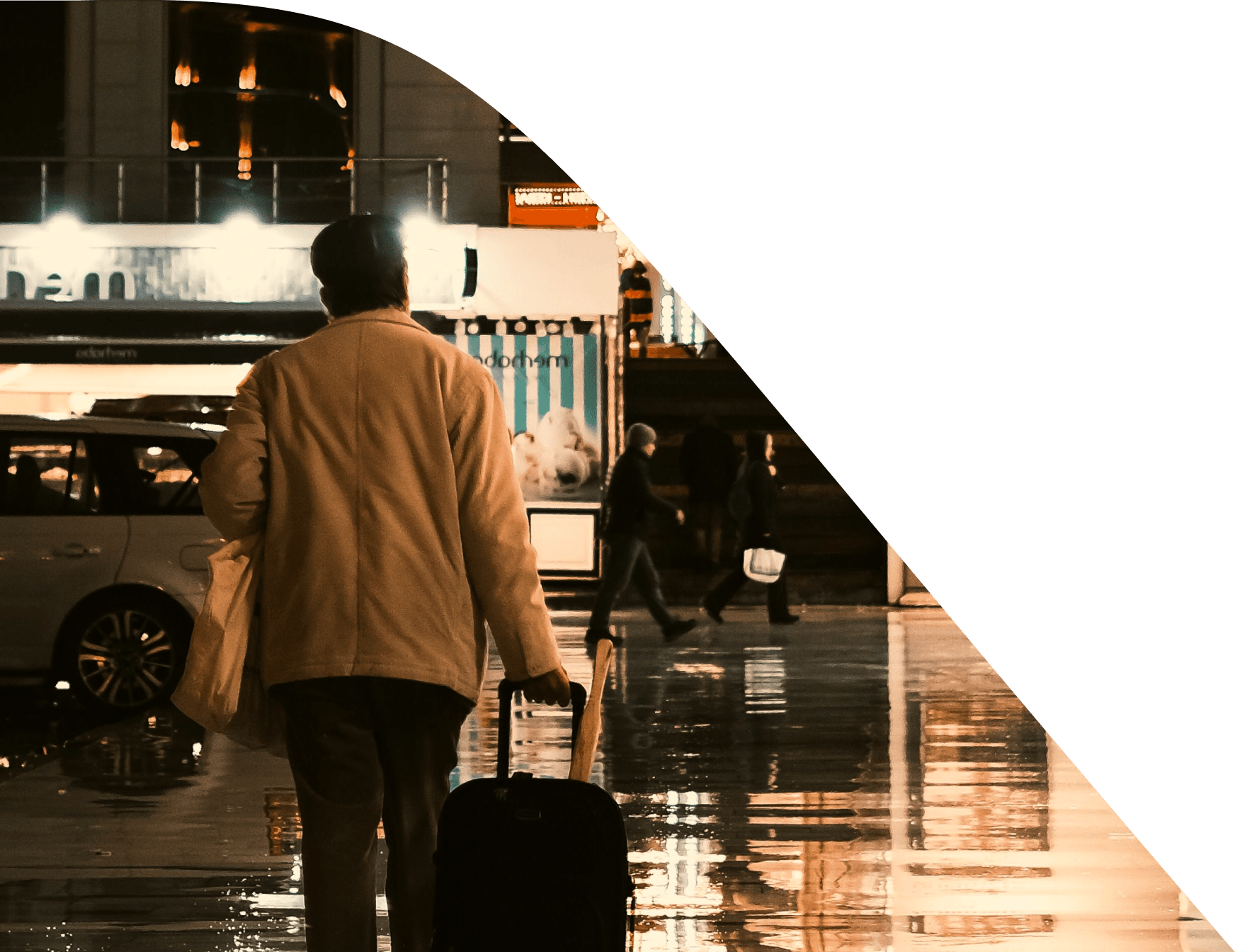 A traveller walking through a terminal with a suitcase